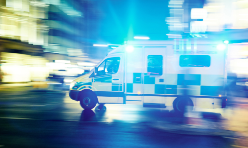 Ambulance driving down the road at night