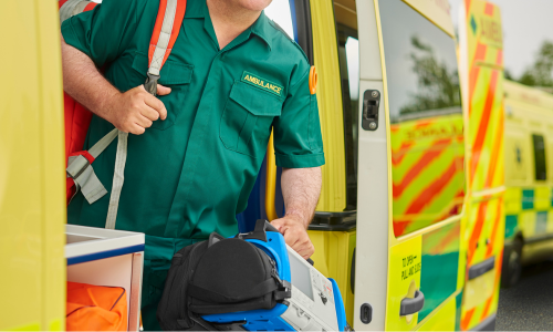 Ambulance clinician coming out of ambulance