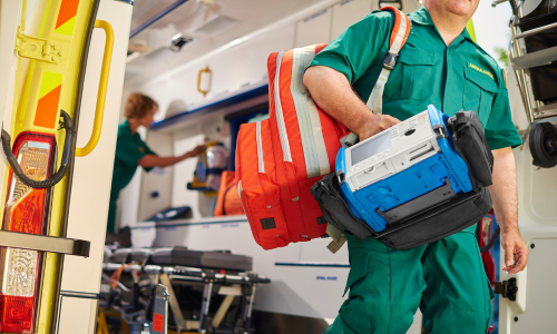 Ambulance clinician walking out of ambulance vehicle