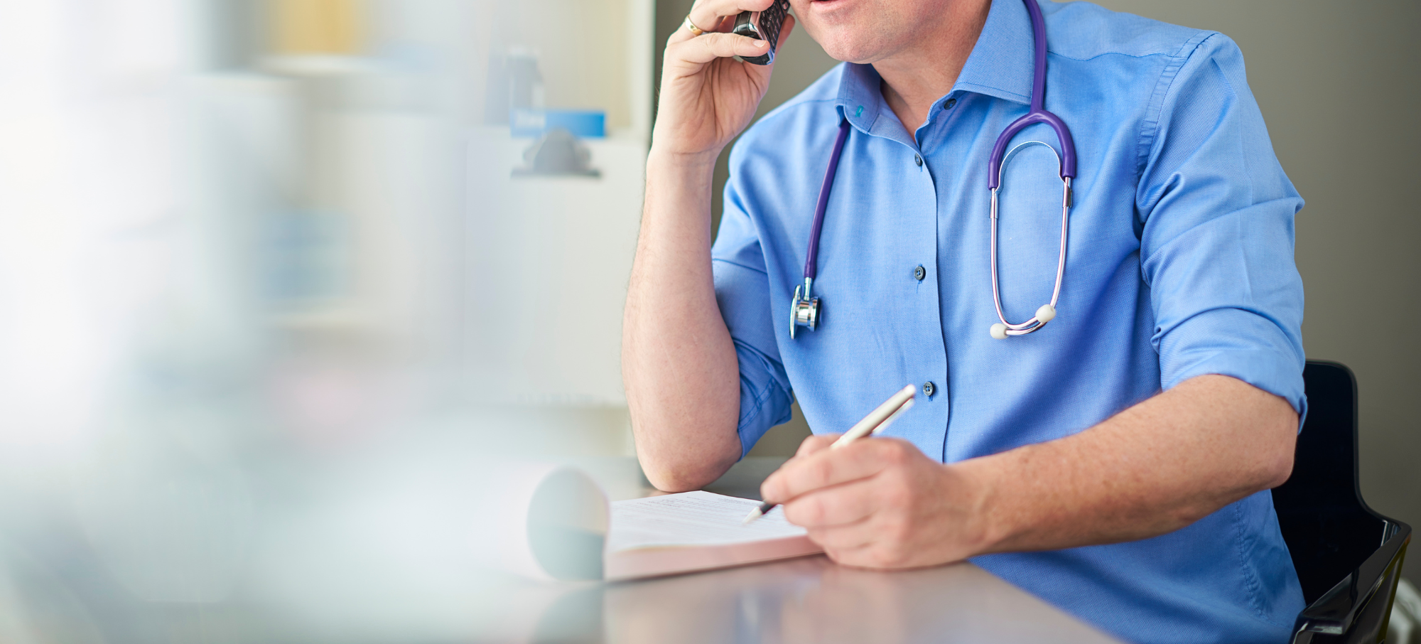 Male clinician on the phone