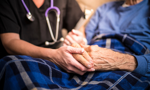 Clinician holding = patient's hand