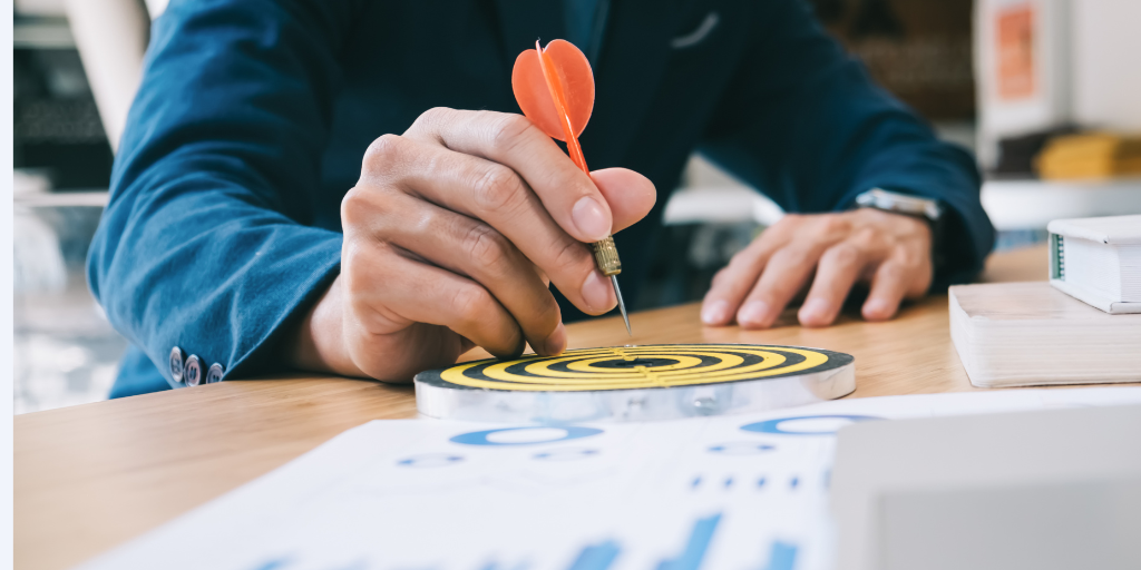Man hitting target on a darts board
