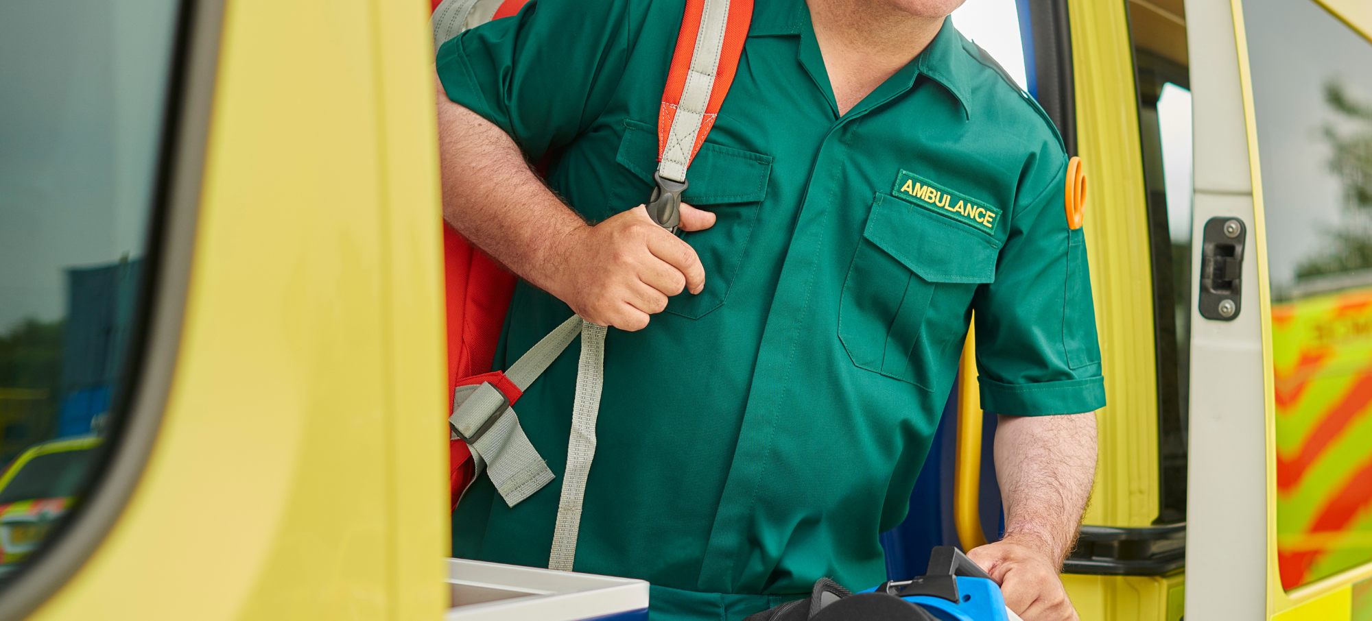 Male paramedic coming out of ambulance